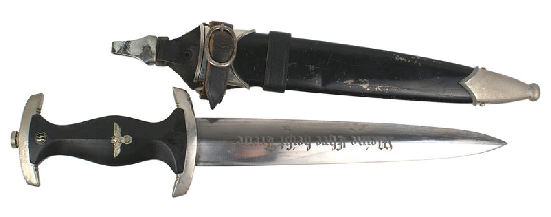 German WWII SS M1933 EM dagger: D-011 German WWII SS M1933 EM dagger. Same design as the SA but with a black wood grip with silvered eagle/swastika and an enameled "SS" roundel. An aged patina on the nickeled crossguards. Clean blad