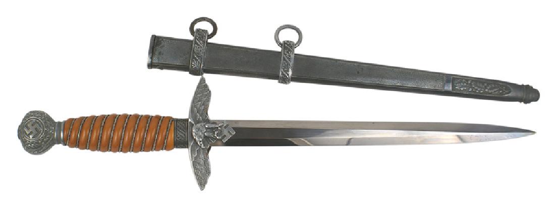 German WWII Luftwaffe dagger 2nd Model: D-026 German WWII Luftwaffe 2nd Model dagger. Aluminum swastika/oak leaf decorated pommel and flying eagle/swastika crossguard. Twisted silver wire wrapped orange grip. Clean 10 1/4" blade. Maker mark