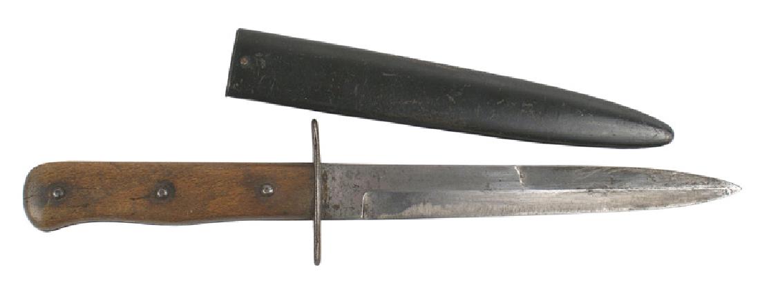 German WWII boot knife: D-104 German WWII boot knife. Shaped wood handle with three relief rivets. Short steel crossguard. 6 5/8" graying blade was sharpened and shows use. Marked with an eagle's wing / "5". Black enameled s