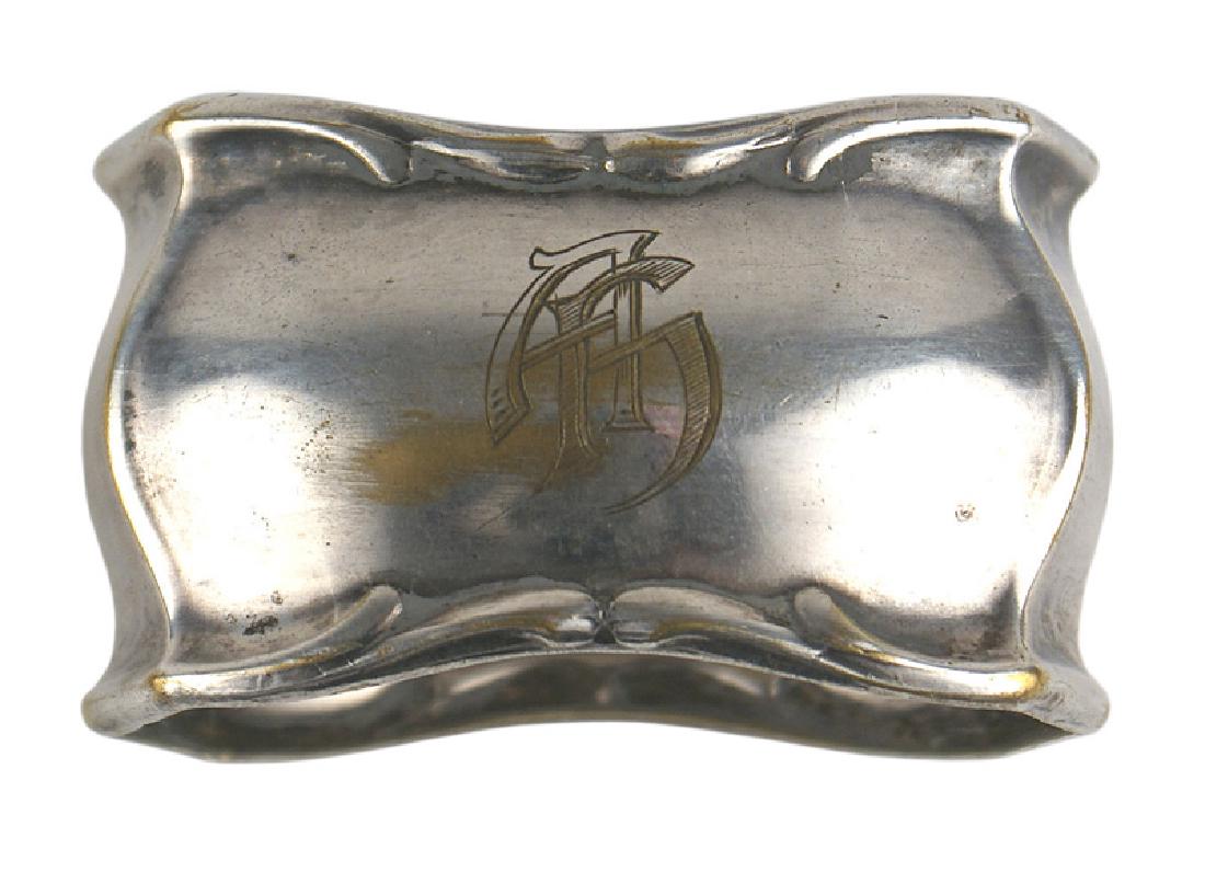 Adolf Hitler silvered napkin ring: A-025 Adolf Hitler silvered napkin ring. Rectangular-shaped with a small floral leaf border. The convex-shaped front is engraved with an almost gothic style "AH" cypher which is similar to the cypher