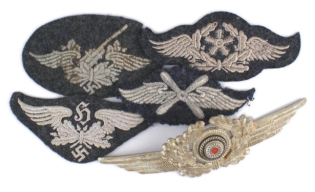 Lot 4 German WWII Luftwaffe sleeve badges: H-045 Lot of 4 German WWII Luftwaffe embroidered sleeve badges: (1) Sound Locater. (2) Flying Technical Personnel. (3) Flying Personnel. (4) Flak. Also a metal winged rosette cap wreath. II