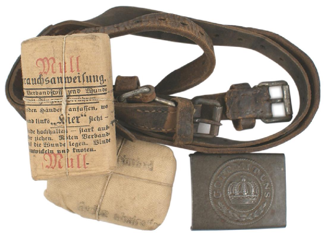 WWI lot German buckle bandage kits straps: H-105 Miscellaneous WWI lot: (1) EM belt buckle - relief crown, oak leaves and "GOTT MIT UNS". (2) Two unopened bandage kits. (3) Three different leather equipment straps (show wear). All are dated. I