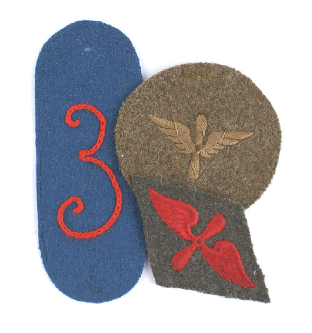 Lot of 3 German WWI cloth uniform insignia: H-116 Lot of 3 German WWI cloth uniform insignia. Includes: (1) Red embroidered winged propeller on a diamond-shaped feldgrau backing. (2) Unknown German 4" x 1 11/16" blue oval with a chain stitched 