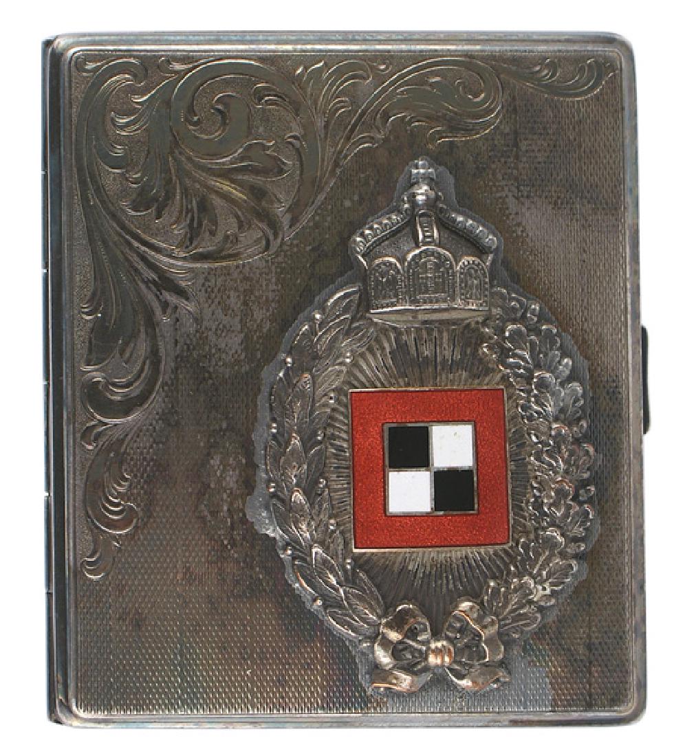 Imperial German aviator cigarette case: H-120 Imperial German aviator's silvered cigarette case. Prussian Observer's Badge skillfully applied to the lid with a fine checkered background and floral engraving. Case shows a nice purple patina.