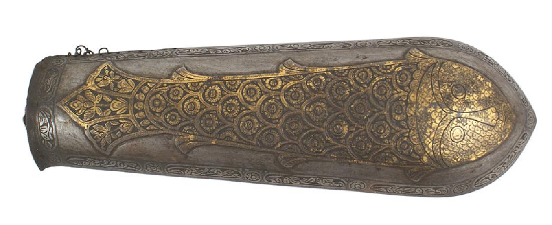 Persian 18th Century Bazu Band vambrace: R-005 Persian 18th Century Bazu Band (vambrace). Curved armor plate which covers the wrist to the elbow. Age darkened gilt decorated, relief engraved 10 1/2" x 3" fish with a human face. Entire border