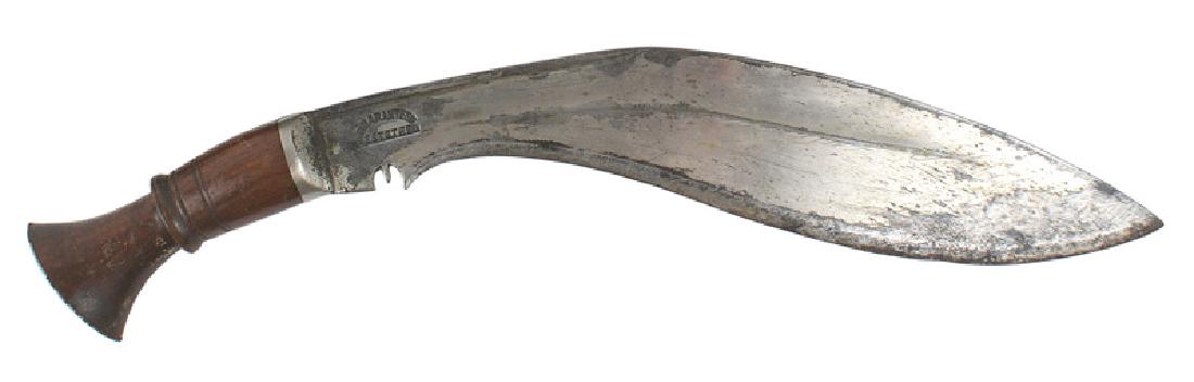 Nepal Gurkha kukri sword knife: R-022 Nepal Gurkha kukri. Turned wood grip with an oval flat nickled pommel and ferrule. Traditional 12 1/4" curved blade which narrows closer to the hilt. Marked "GUARANTEED BESTSTEEL". Some of the n