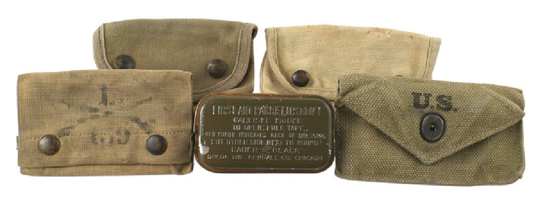 Lot of 3 U.S. First Aid packets WWI WWII: N-055 Lot of 3 U.S. First Aid packets: (1) WWI. OD pouch with snap buttons and a wide brass belt hook. Reverse marked "F. ANSOM". (2) Similar - but faded to a light tan. Name on reverse "F.J. MACKOWIA