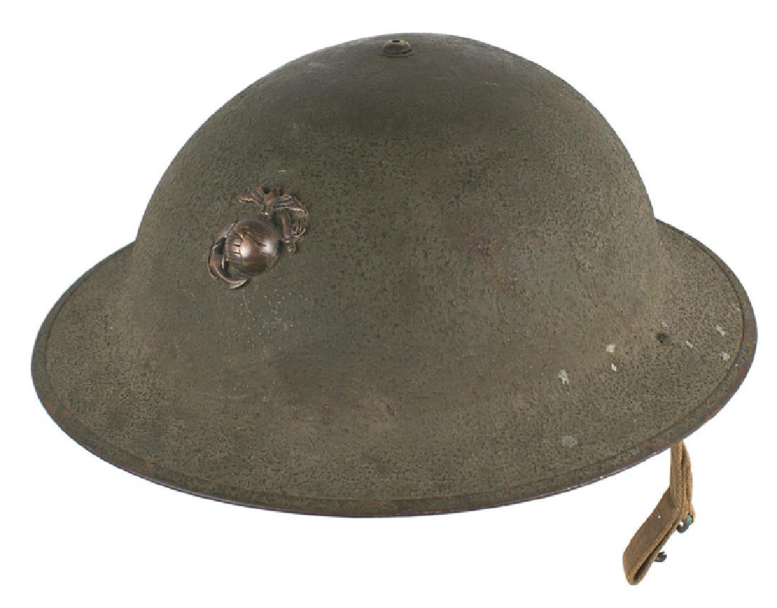 U.S. Marine Corps M1917 A-1 helmet WWI: E-050 U.S. Marine Corps M1917 A-1 helmet. Similar to the WWI "doughboy". OD sand finish with a domed shaped top center rivet and an affixed brass EGA insignia (original as it is closely mounted and sh