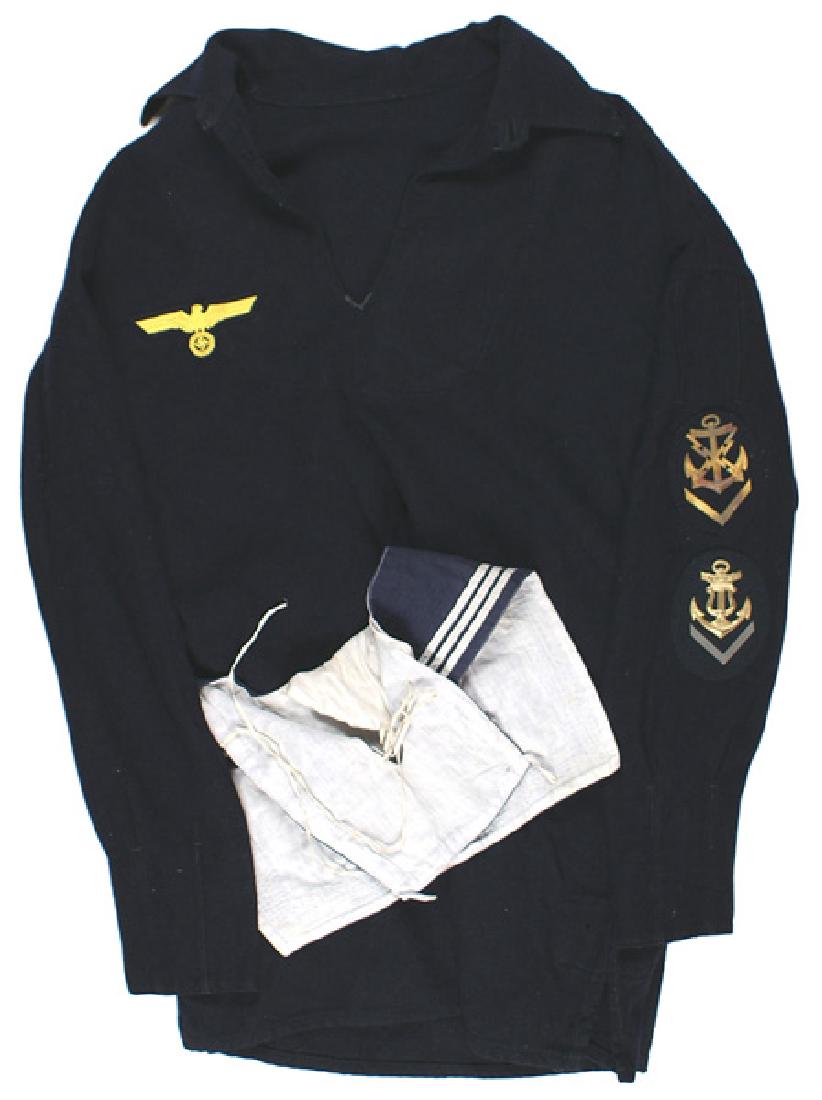 German WWII Kriegsmarine Seaman jumper: F-032 German WWII Kriegsmarine Seaman's blue wool jumper. Embroidered yellow-gold on dark blue breast eagle/swastika. Two gilt-metal on dark blue cloth career badges: Fernschreibmaat (Teletypist) and