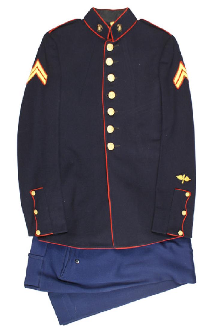 U.S. Marine Corps WWII dress blue uniform: F-081 U.S. Marine Corps WWII dress blue uniform. Red piped collar, front, and cuffs. Embroidered silk Corporal chevrons. Winged prop insignia on left cuff. Gilt brass EAG collar insignia. Gilt eagle/a