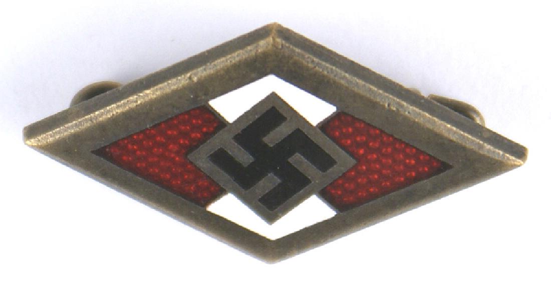 German WWII Hitler Youth Golden Badge of Honor: B-120 German WWII Golden Hitler Youth Badge of Honor. Black enameled swastika on a red/white enameled diamond with an age darkened gold border and background. Reverse is marked "RZM", "M1/70", "GES. G