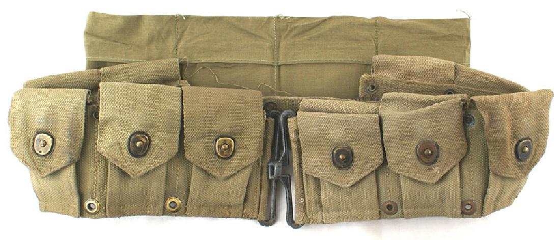 U.S. WWII Marine Corps M1910 cartridge belt: M-101 WWII U.S. Marine Corps M1910 cartridge belt. Ten snap dot pockets. Reverse is marked "U.S.M.C." and "BOYT-43". Shows some wear. Also with six-pocket OD cotton ammo belt. II