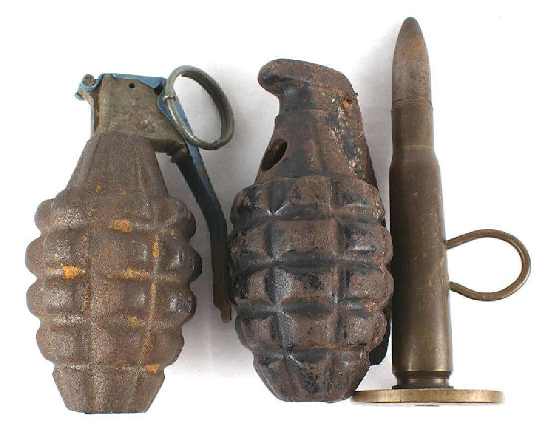 U.S. lot WWII pineapple grenade training grenade: M-123 U.S. lot of WWII Ordnance: (1) WWII "pineapple" grenade. Complete with handle/pin. Paint worn from body. Dewat. (2) Period one-piece cast training grenade. Most of paint is worn away. (3) 50 cal