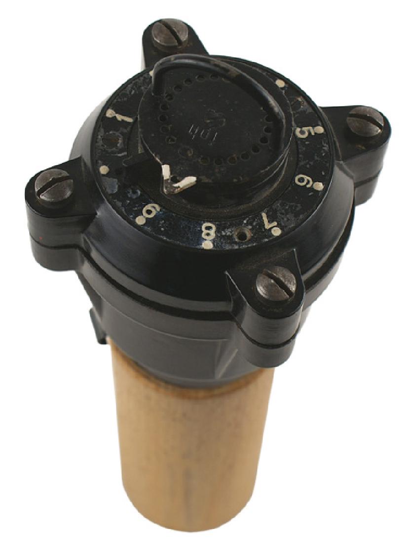 German WWII timing device V1/V2 rocket: M-130 German WWII delayed timing device for the V1/V2 rocket. Made of bakelite. Marked "foh". With a hollowed-out wood base - which allows the device to stand in a vertical position. Rare. II+