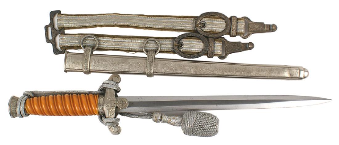 German WWII Army Officer dagger: D-007 German WWII Army Officer dagger. Orange grip. Oak leaf decorated pommel and ferrule. Relief eagle/swastika crossguard. 10" clean blade - marked with logo and name of maker "A.W. JR. SOLINGEN". S