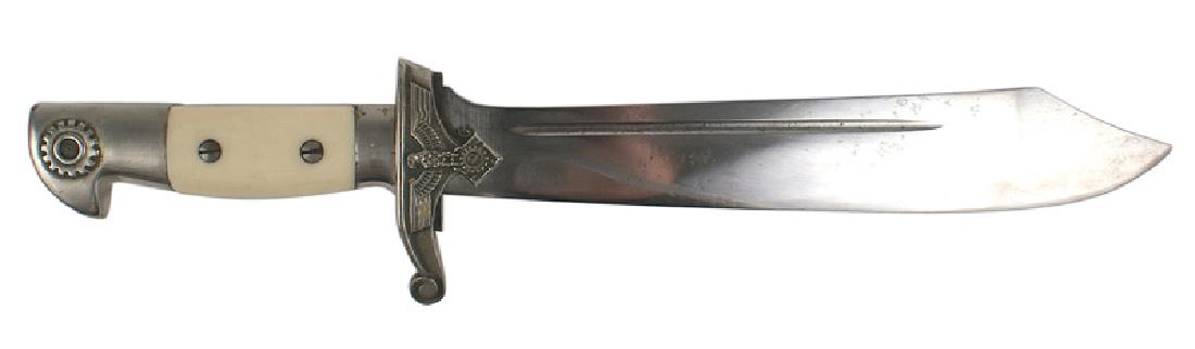 German WWII TN Technical Corps hewer dagger: D-013 German WWII TN (Technical Corps) E.M. hewer. Nickeled eagle head pommel bearing a relief cogwheel. White bakelite grips. Eagle/swastika/cogwheel on crossguard. 9 5/8" scimitar type blade marked 