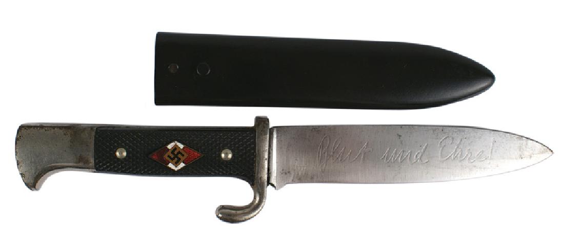 German WWII Hitler Youth dagger HJ: D-014 HJ (Hitler Youth) dagger. Some wear to the finish on the nickeled pommel and turned-up crossguard. Enameled HJ diamond/swastika set into the checkered black bakelite grip. 5 1/8" blade is etched