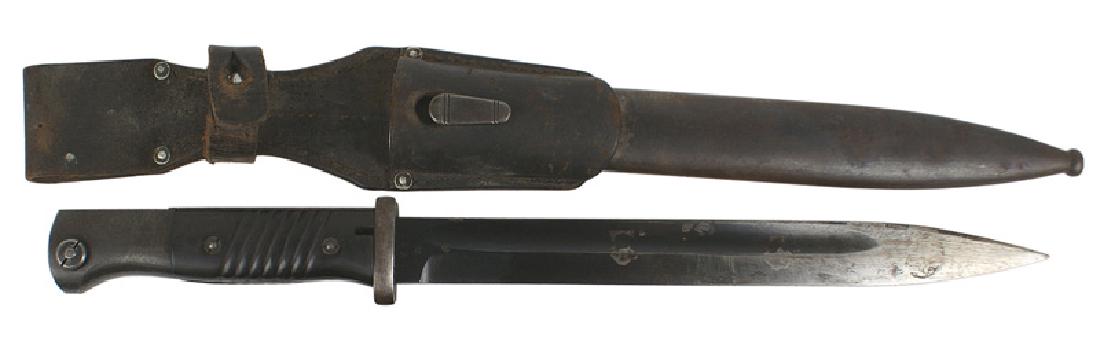 German WWII K-98 Mauser bayonet: D-041 German WWII K-98 Mauser bayonet. Blued pommel, backstrap and crossguard. Deep purple bakelite grips. Approximately 70% blued finish - remaining area shows graying and minute pitting. Blade is nu