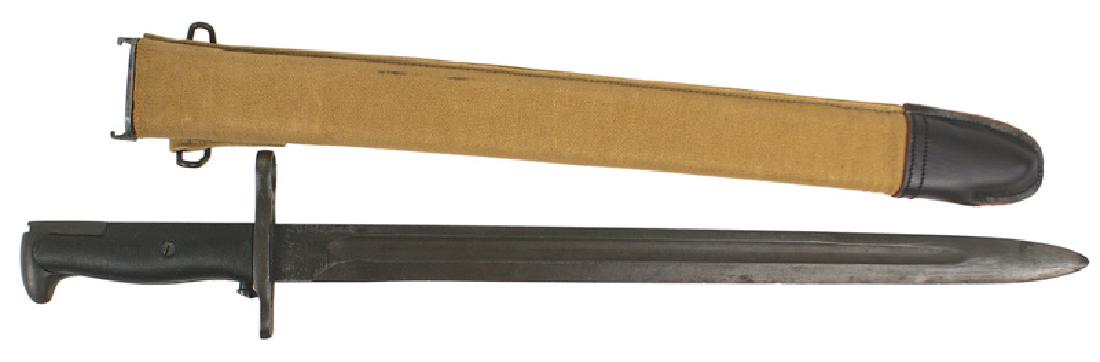 U.S. WWII M1942 Garand bayonet: D-070 U.S. M1942 Garand bayonet. Blued steel pommel and crossguard. Ribbed black plastic grips. 15 7/8" blade marked "U.F.H.", flaming grenade with "US" and "1943". 1" of the tip shows some wear, rema