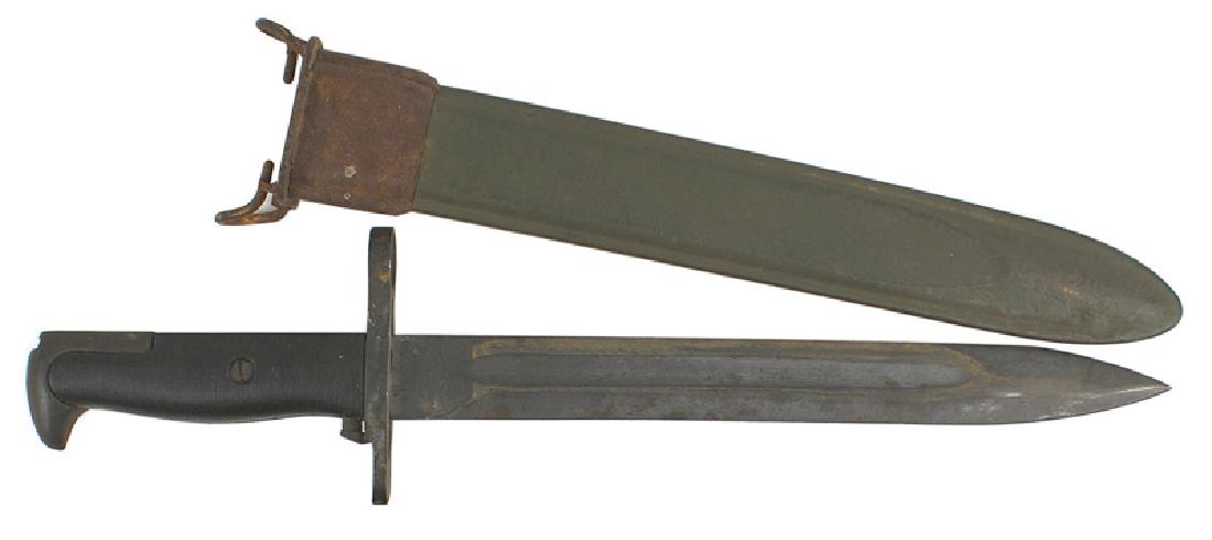 U.S. M1905 E-1 Garand Bayonet M-1: D-073 U.S. M1905 E-1 Garand (Bayonet M-1). Parkerized pommel and crossguard. Ribbed black plastic grips. 80% of the parkerized finish on the 9 1/8" blade remains. Maker marked "U.F.H." above a flaming