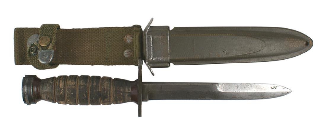 U.S. WWII M-4 bayonet: D-076 U.S. WWII M-4 bayonet. Flat pommel and leather rings grip. Crossguard is marked "US M4-PAL". 6 1/2" blade shows wear and is graying. "U.S. M8 A1" scabbard. OD fiber material with a web belt loop