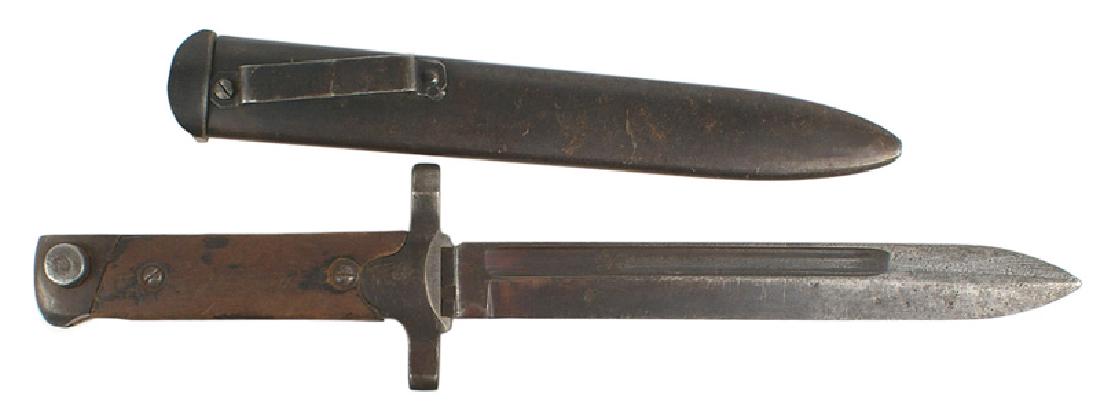 Italian M1891 Non-folding bayonet: D-082 Italian M1891/38. Non-folding type. Darkened steel pommel and short crossguard with a muzzle ring. Wood grips. 7" blade with 60% of the original blued finish. Shows some use and light pitting ne