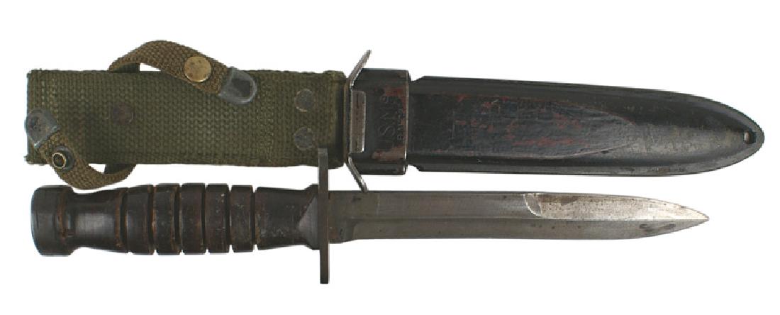 U.S. M4 bayonet fighting knife: D-099 U.S. M4 bayonet modified to a fighting knife. Slot on pommel was filled and press stud removed. Crossguard narrowed and muzzle ring spit and "pinched". 7 5/8" blade shows some use. M8 scabbard (