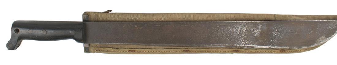 USMC WWII machete: D-106 U.S.M.C. WWI machete. Black wood grips with four rivets. 18" blade which shows use, is lightly pitted and completely dark from age. Marked "US", the company logo and "LEGITIMUS - COLLINS & CO 19