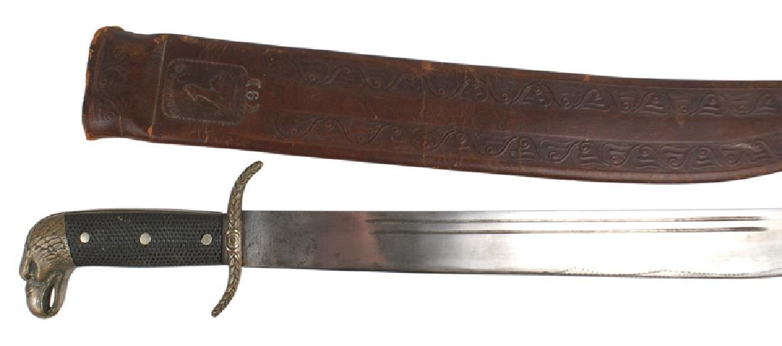 U.S. late 19th Century machete: D-109 American made late 19th Century machete. Age toned brass defined eagle head pommel with a floral decorated "S" crossguard. Three rivets on the black checkered grips. 17 7/8" straight clean blade