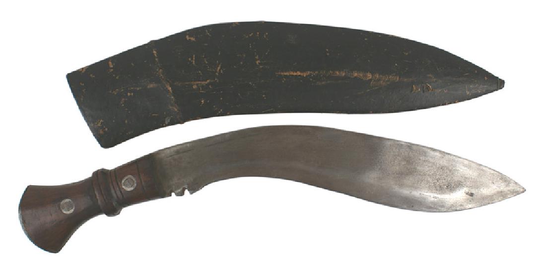 British WWI military issue Gurkha Kukri: D-113 British WWI military issue Gurkha Kukri. The traditional knife of Nepal, carried by Gurkha troops. Rounded steel pommel on a carved wood grip with a high center ridge. Two steel rivets. 13" curv