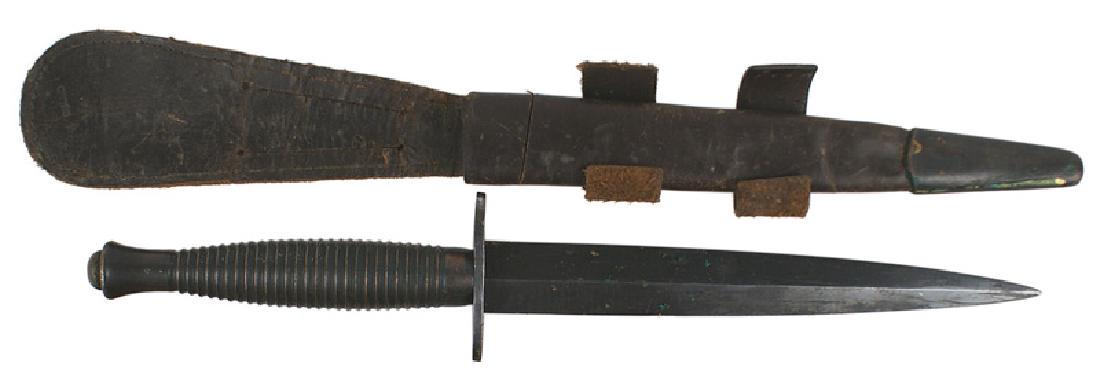 British WWII Fairbairn combat knife: D-120 British WWII Fairbairn combat knife. Type 2. Darkened ridged handle. Number "4" on pommel. Crossguard is marked "ENGLAND". 6 7/8" blade retains 95% of the blued finish and shows some age spottin