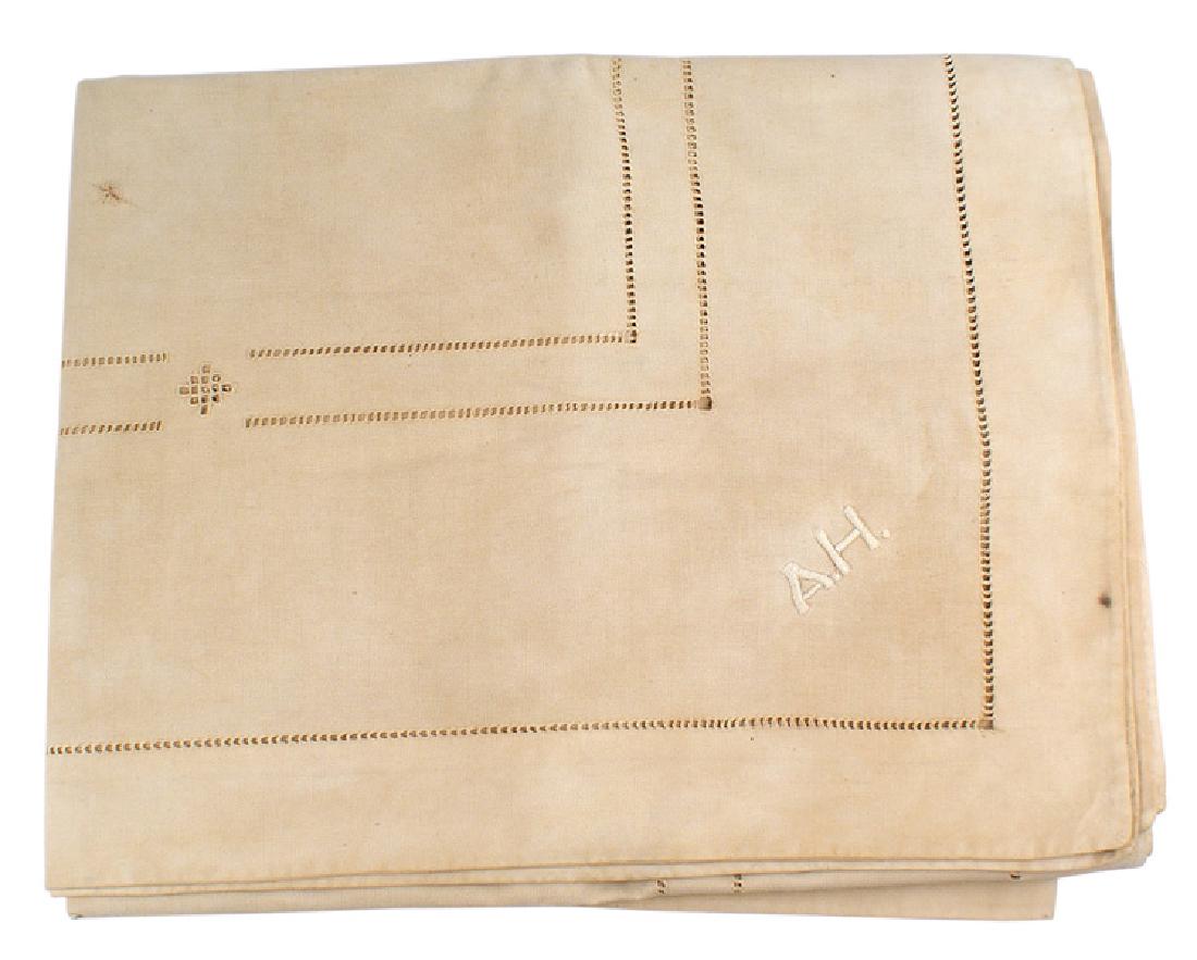 Adolf Hitler personal service table cover: A-026 Adolf Hitler personal service linen table cover. Inner-perforated linear design and perforation 1 7/8" along the entire border. One of the covers has a relief embroidered "A.H.". Table cover has