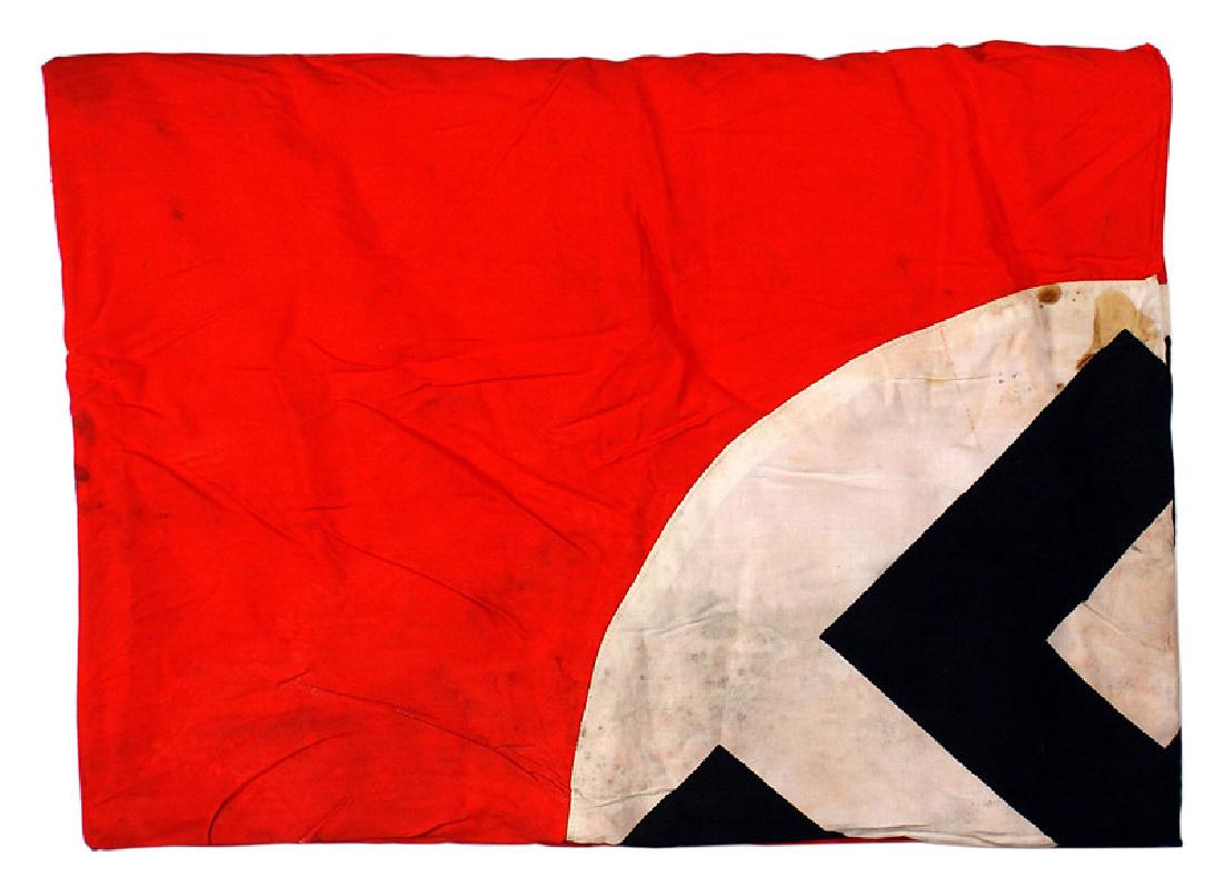 German WWII NSDAP banner flag: H-086 German WWII N.S.D.A.P. banner. Black swastika printed on the white center - sewn to a red field. Sleeve for suspension. Small tear on edge and soiled. With the original paper tag. 96" x 45". II-