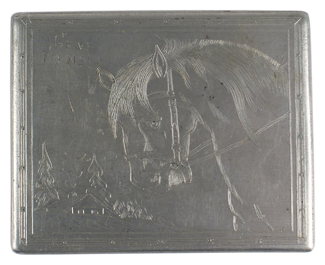 American made POW aluminum cigarette case: H-175 American made POW aluminum cigarette case. Hinged lid is nicely engraved with a horse, view of a home and the name "GENE POWELL". Inside of lid is engraved "GENE POWELL JUNIOR". Sides of the box