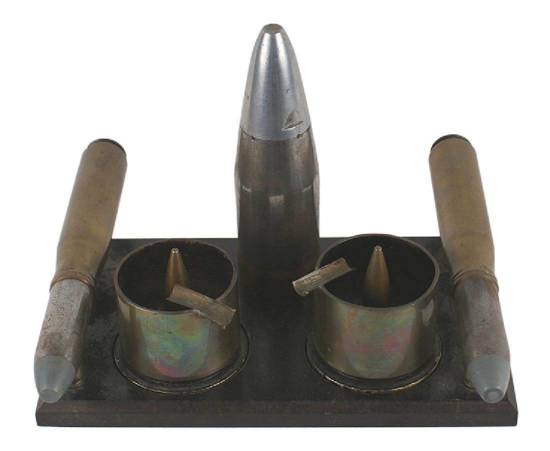 U.S. WWII decorative desk piece ash tray: H-189 U.S. WWII decorative desk piece/ash tray. 5" x 8 1/2" x 1/2" black marble base which has attached two 20mm MK-2 cartridges and a 6" MK-2 armor piercing projectile. The base has also been recesse