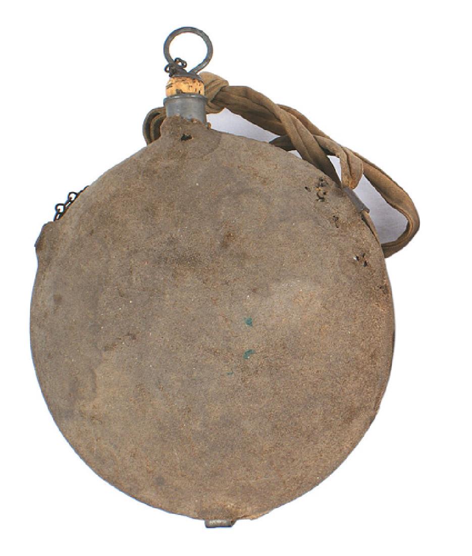 U.S. Civil War M1858 canteen Cavalry: K-041 U.S. M1858 canteen. Complete with cork stopper and chain. Original wool covering is soiled. Cloth shoulder strap is knotted at the 2/3 point - a usual practice of Cavalrymen. About II