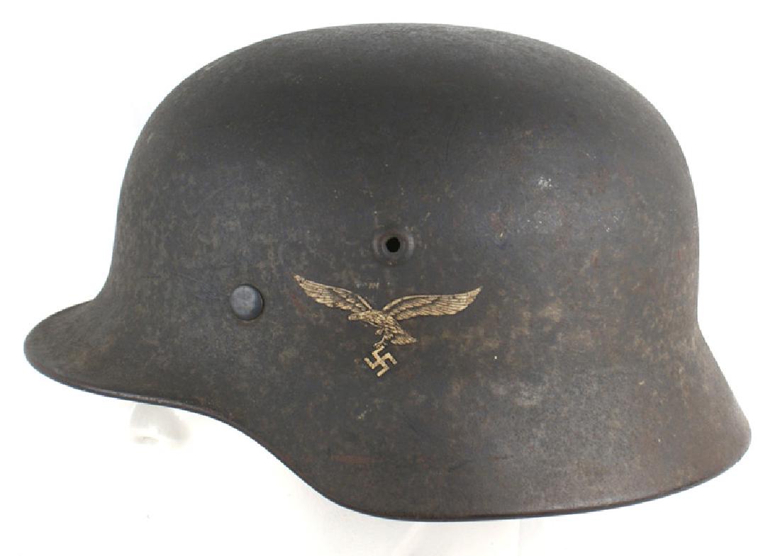 German WWII Luftwaffe M1940 helmet: E-031 German Luftwaffe M1940 single decal helmet. 80% original blue-gray finish. 98% eagle decal. Tan leather drawstring liner. Missing chinstrap. II