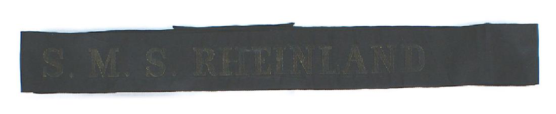 Imperial German Battleship RHEINLAND cap tally: E-142 Imperial German Navy Battleship - "S.M.S. RHEINLAND" cap tally. Aged toned gold lettering on black. The "Rheinland" took part in operations in the North Sea, The Battle Jutland, the Black Sea, G