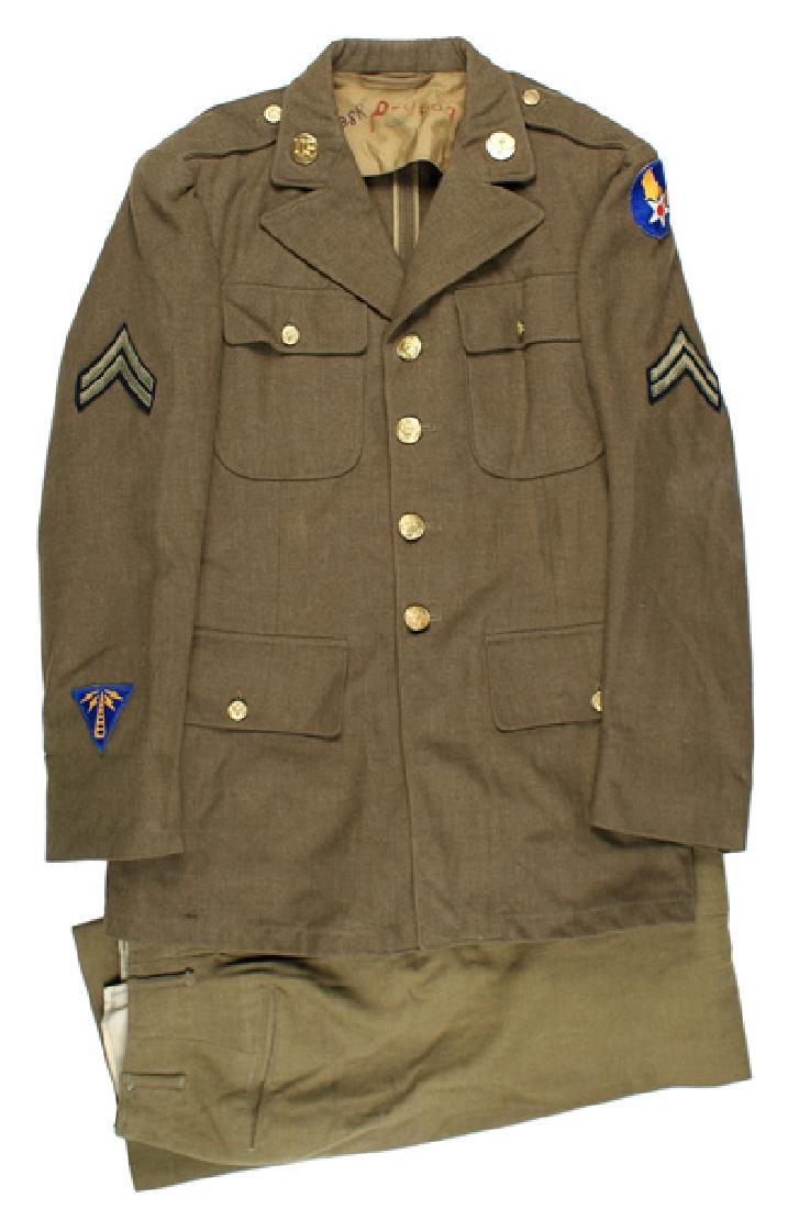 U.S. WWII Army Air Force uniform lot tunic: F-064 WWII Army Air Force uniform lot. Includes: (1) M1939 OD wool, 4-pocket, open collar tunic. "US" and winged propeller collar discs. Embroidered Corporal chevrons, USAAF shoulder patch and Communi