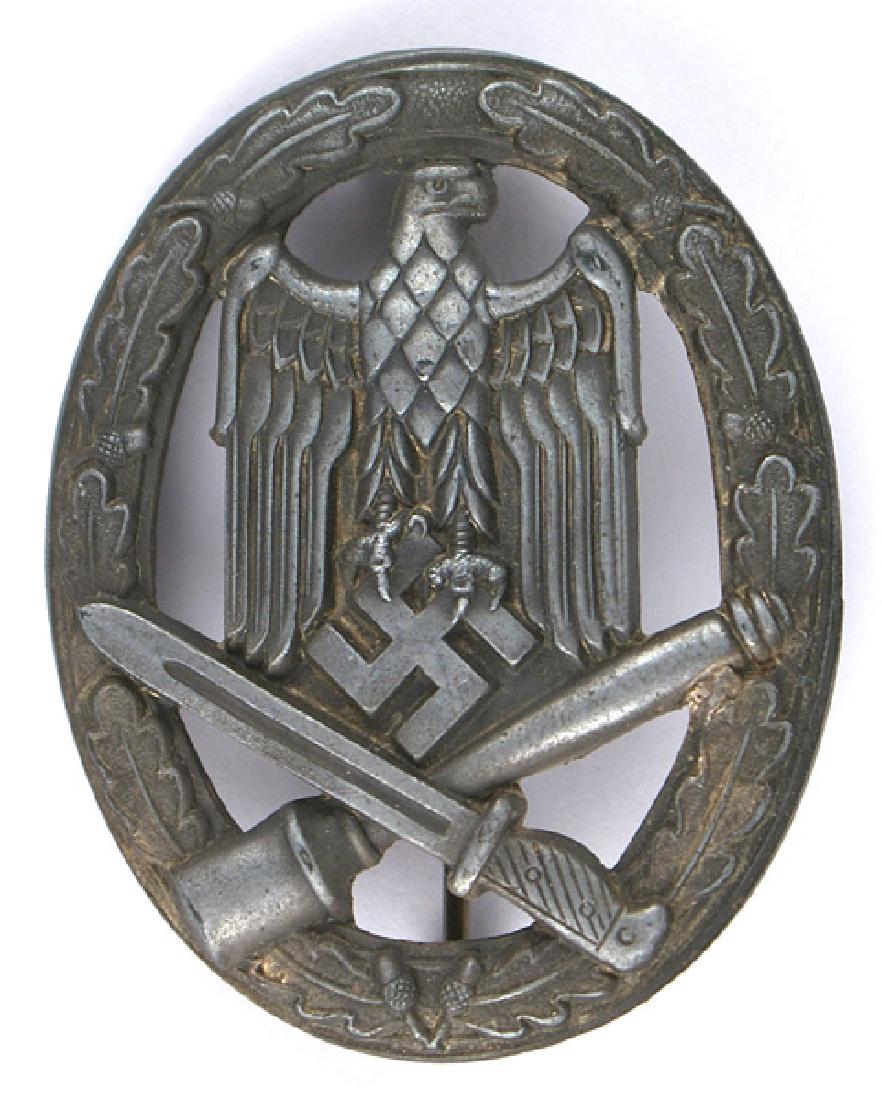 German WWII General Assault Badge: B-131 General Assault Badge. Stamped. Wartime type. Cut-out oak leaf wreath bearing an eagle/swastika and crossed bayonet/stick grenade. Nice detail, but only small traces of silver on reverse. Vertic