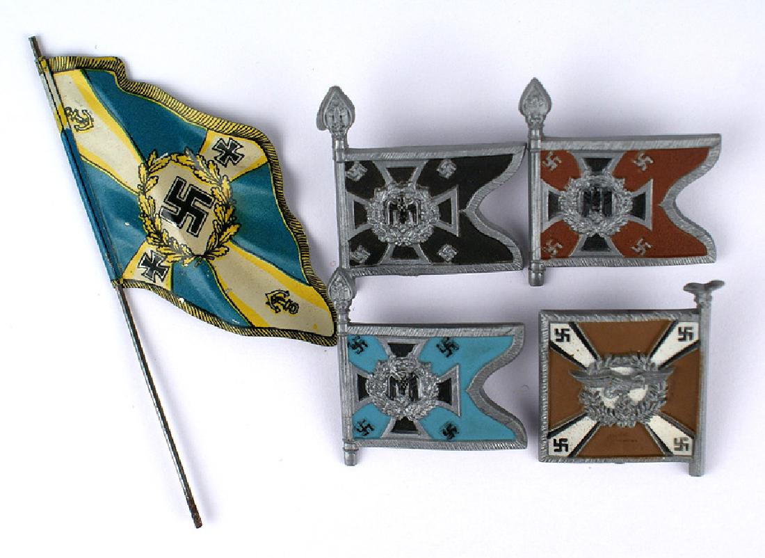 Lot 4 German WWII tinnies plastic standards flags lapel: B-173 Lot of 4 Third-Reich "tinnies" - plastic standards lapel pins: Army Battalion (Pioneer, Artillery and Transport) and a Luftwaffe Signal Regiment. Also a Lineol/Elastolin Kriegsmarine toy soldier
