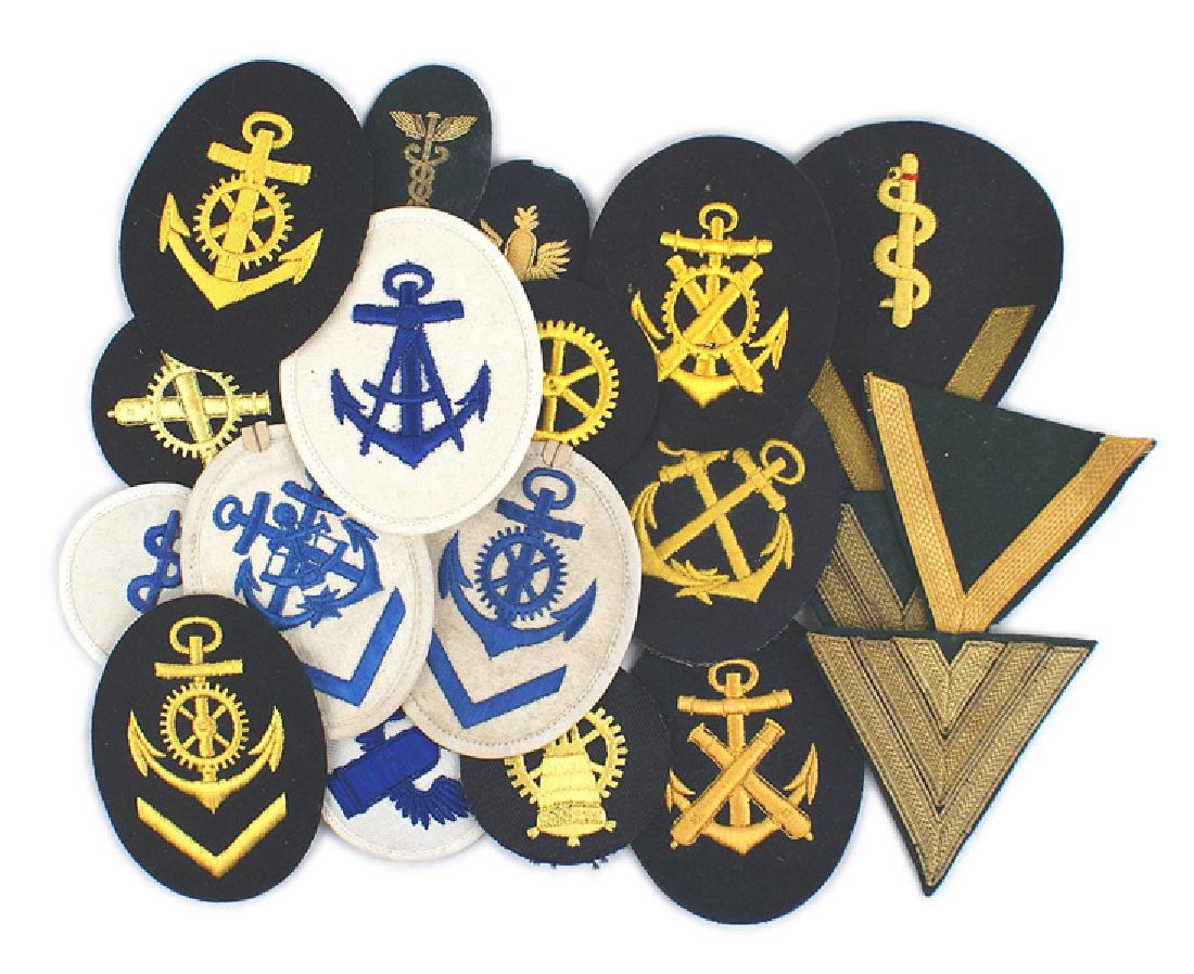 Lot of 23 German WWII Kriegsmarine badges: H-060 Lot of 23 different Kriegsmarine embroidered rank career and rating badges. With both blue and white backed insignia. Includes a white Navigating Helmsman/coxswain career badge and officer gold