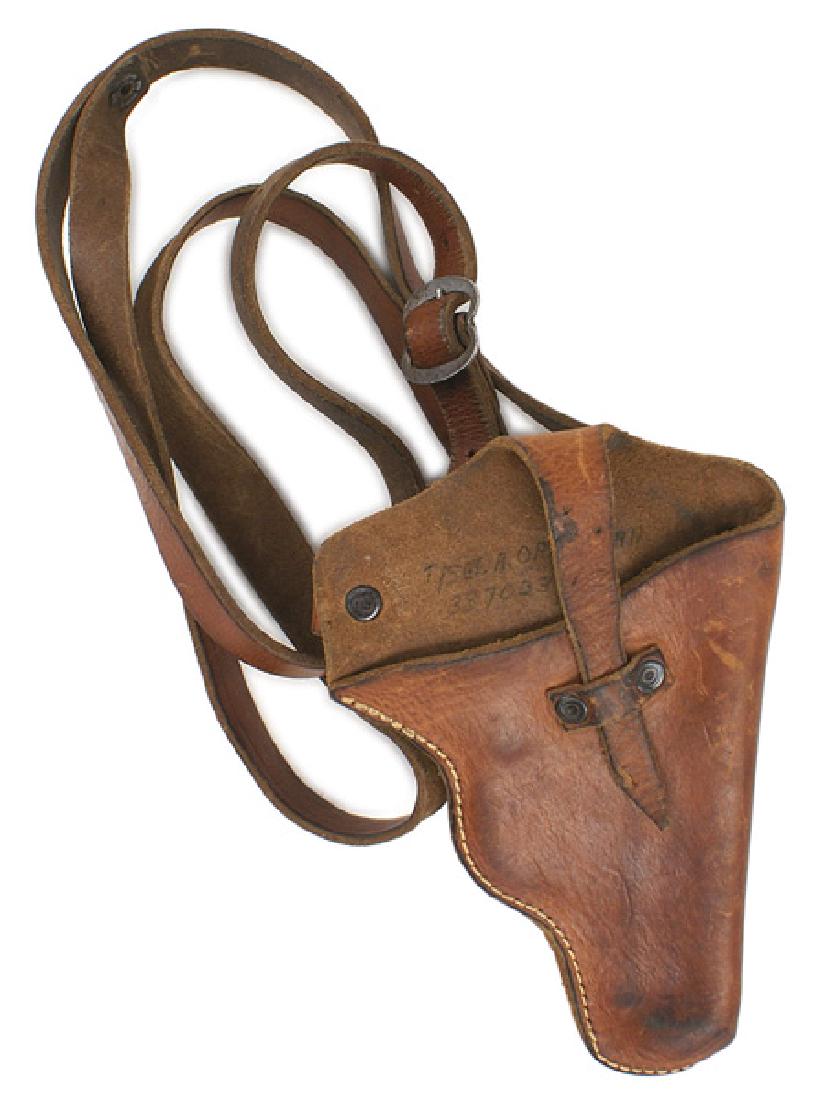 German WWII shoulder holster pistol: M-046 German WWII leather shoulder holster. Probably for a 6.35 type pistol. German made with a shoulder and attached chest strap. A U.S. GI has written his name on the holster. II