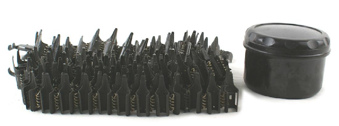 German WWII MG34 42 lot tabs ammo: M-063 Lot of accessories for the MG 34/42: (1) Three starter tabs. (2) Bakelite grease container. (3) Three 34" metal ammo belts. I