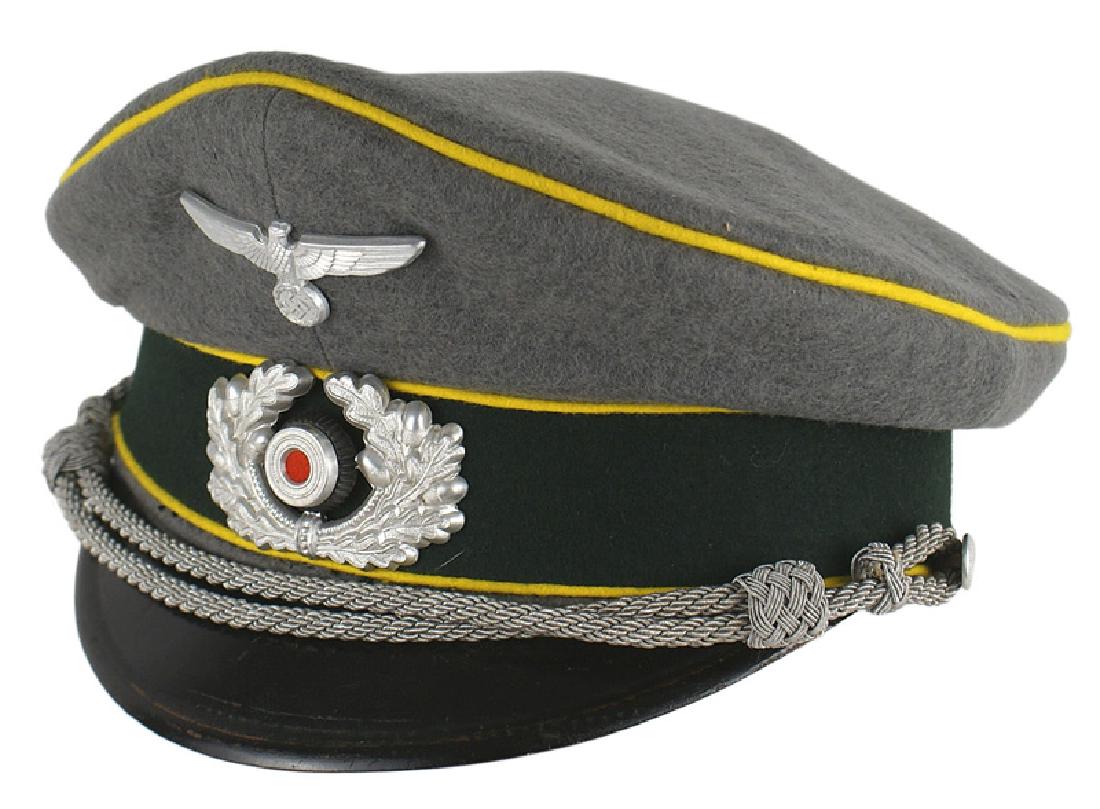 German WWII Army Signal peaked cap: E-050 German Army Signal officer's peaked cap. OD wool with a black band and yellow piping. Silver metal eagle/swastika and oak leaf wreath/rosette (red felt center). Two minor tracks on left top side