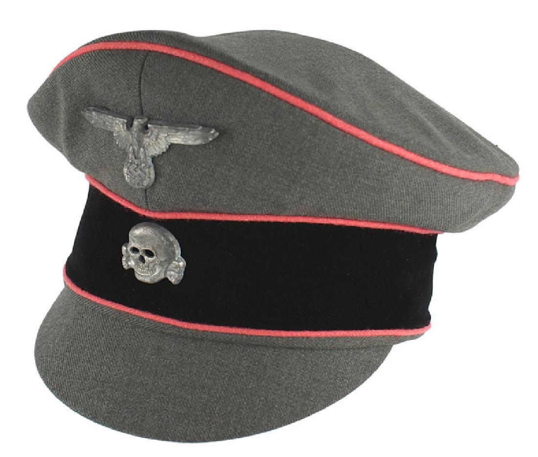 German WWII Waffen SS Panzer field cap: E-057 Waffen-SS M1938 "old style" Panzer officer's field cap. OD body and cloth covered visor. Pink piped crown and black velvet band. Age toned metal SS eagle/swastika and skull insignia. Tan leather
