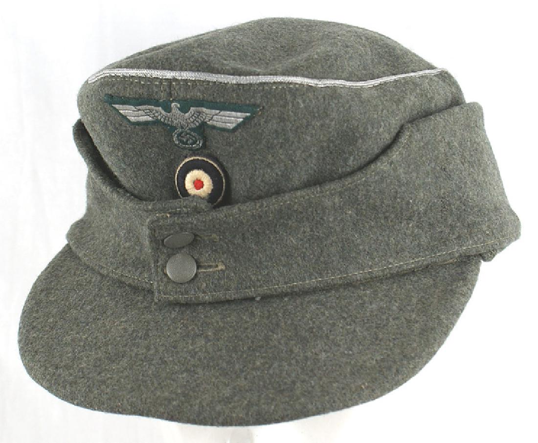 German WWII Army officer M43 cap: E-120 Late Addition to our headgear section: Third-Reich Army officer's M43 cap. Silver cord piping around crown. Bevo type silver eagle/swastika and relief embroidered cockade. Silk type lining is st