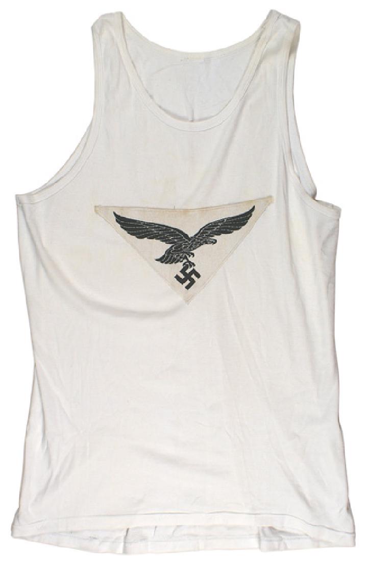 German WWII Luftwaffe PE sport shirt: F-019 German WWII Luftwaffe physical training sport shirt. Sleeveless white cotton "T" shirt with a machine - sewn 5 1/2" x 11" triangular black bevo embroidered flying eagle/swastika inverted triangu
