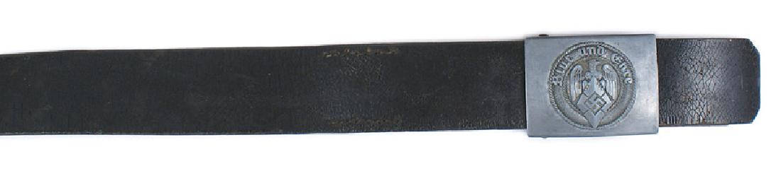 German WWII Hitler Youth belt and buckle: F-057 Hitler Youth black leather belt and buckle. One-piece gray steel buckle with a relief eagle/diamond/swastika and "Blut und Ehre". Reverse is marked "RZM" and "M4/38". Belt is marked with the nam