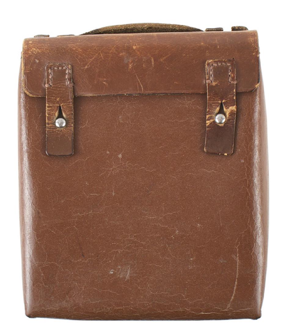 German WWII Army Medic leather case: N-009 German WWII Army Medic's brown hard leather case. 8 1/4" x 7" x 2 1/2". With a handle and two "D" rings. Fold-down type with upright compartments for instruments. Reverse is marked "Sanitatslage